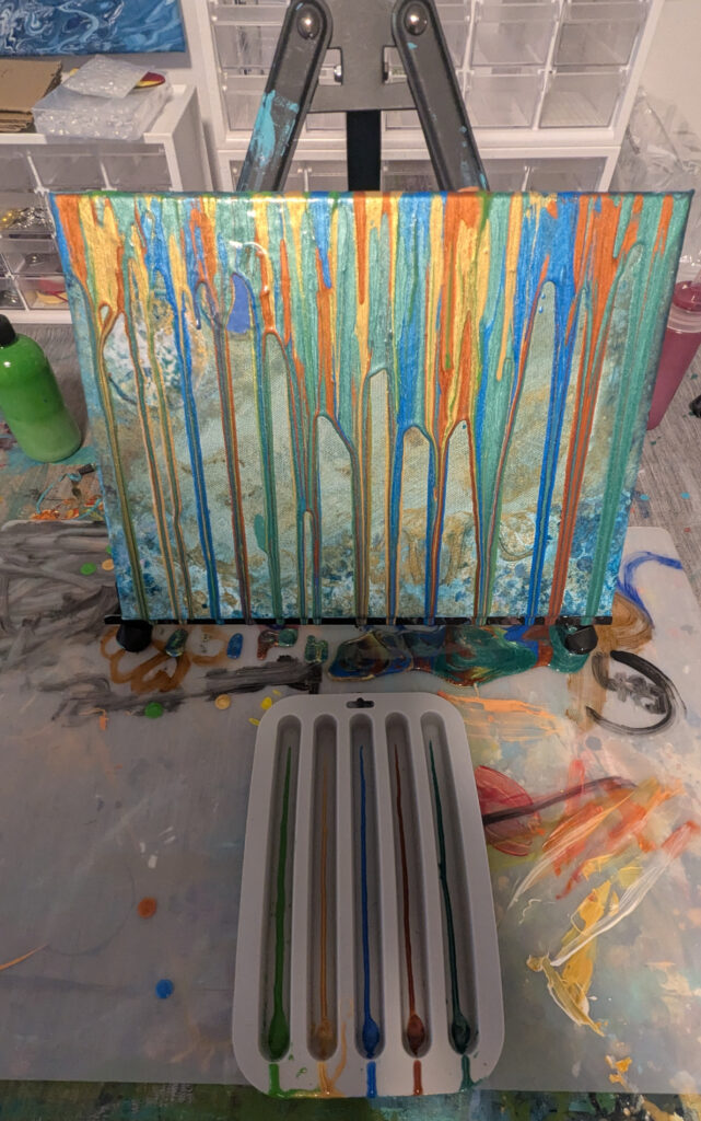 Using silicone trays to pour five streams of metallic paint.